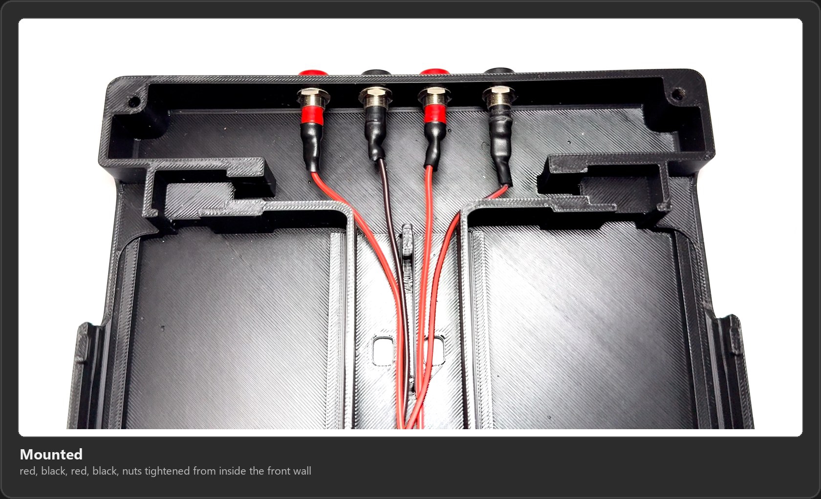 The four banana jacks mounted in the front wall, red, black, red, black, with heat shrink over the joints and the wires running back toward the center channel